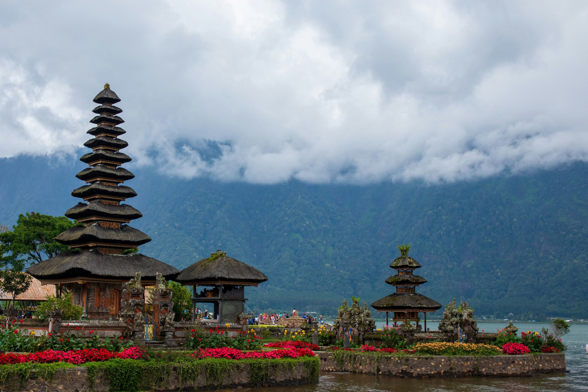 Temple by a lake with mountains in the background